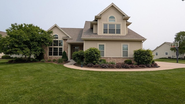 N100W17560 Whitetail Run, Germantown, WI 53022 - view of front facade with a front yard, stone siding, and roof with shingles