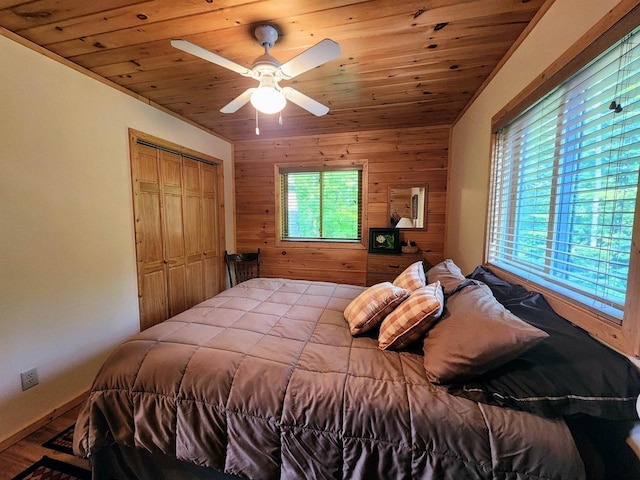 5872W Otter Ln, Winter, WI 54896 - bedroom with wooden walls, wood ceiling, a ceiling fan, and a closet