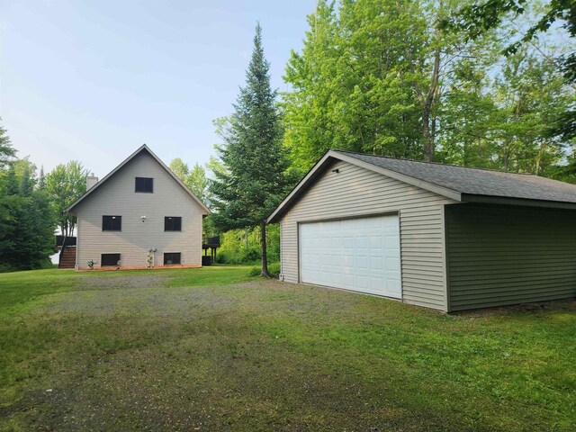 5872W Otter Ln, Winter, WI 54896 - view of side of property with a garage, an outbuilding, a chimney, and a lawn