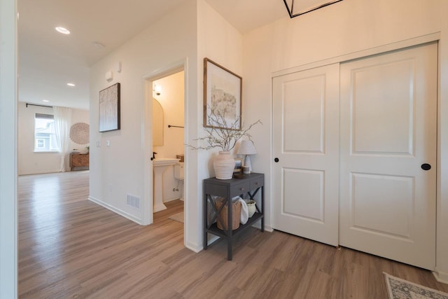 N56W24235 Torrey Pines Ln, Sussex, WI 53089 - hallway with light wood-style floors and recessed lighting
