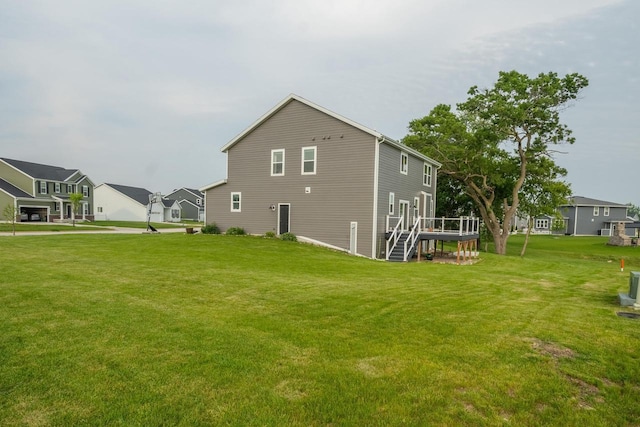 N56W24235 Torrey Pines Ln, Sussex, WI 53089 - view of property exterior featuring a lawn, a deck, and stairway
