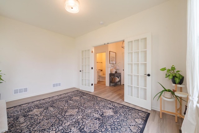 N56W24235 Torrey Pines Ln, Sussex, WI 53089 - bedroom featuring french doors and wood finished floors