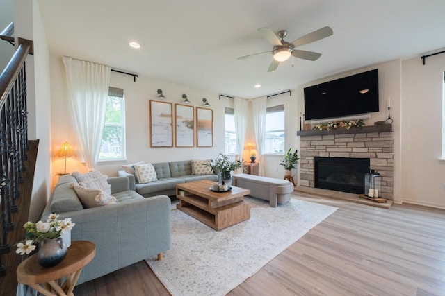 N56W24235 Torrey Pines Ln, Sussex, WI 53089 - living room with plenty of natural light, wood finished floors, ceiling fan, a stone fireplace, and recessed lighting