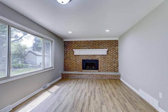 329 Meadow Ln, Deforest, WI 53532 - unfurnished living room featuring wood finished floors, a fireplace, and recessed lighting