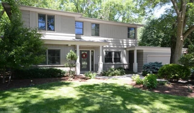 340 W Indian Creek Ct, Fox Point, WI 53217 - view of front of property featuring a garage and a front lawn