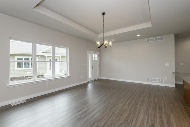 20900 Gray St, Lannon, WI 53046 - unfurnished room featuring a raised ceiling, dark wood finished floors, a chandelier, and recessed lighting