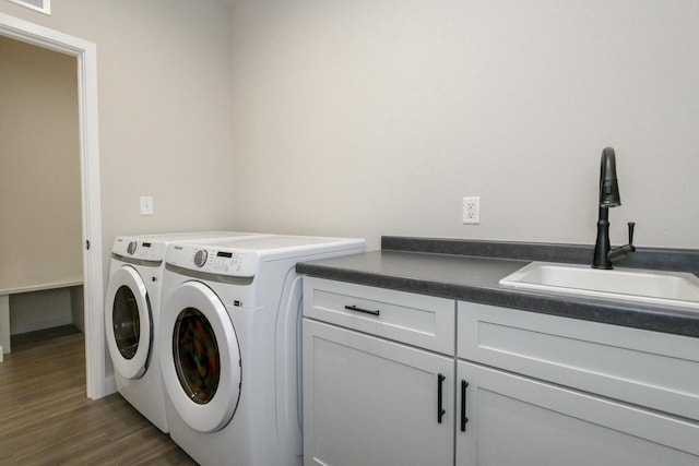20900 Gray St, Lannon, WI 53046 - washroom featuring washer and clothes dryer, cabinet space, and dark wood-style flooring