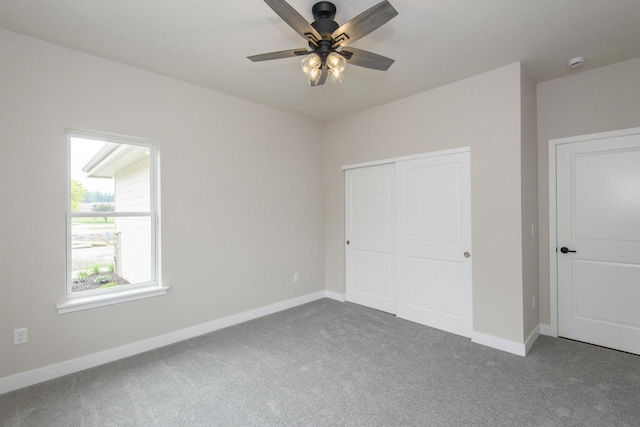 20900 Gray St, Lannon, WI 53046 - unfurnished bedroom featuring carpet flooring, a closet, and a ceiling fan