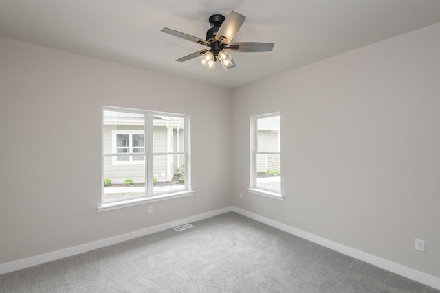 20900 Gray St, Lannon, WI 53046 - carpeted empty room featuring healthy amount of natural light and a ceiling fan