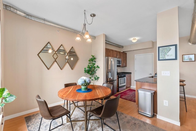 1541 N Jefferson St Unit 408, Milwaukee, WI 53202 - dining room with light wood-style floors and baseboards