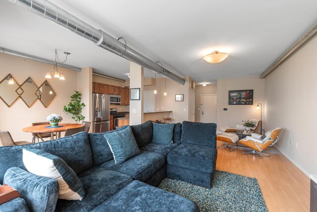 1541 N Jefferson St Unit 408, Milwaukee, WI 53202 - living area featuring light wood finished floors and baseboards