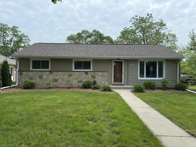 4410 N 107th St, Milwaukee, WI 53225 - ranch-style house featuring stone siding, a front yard, and roof with shingles