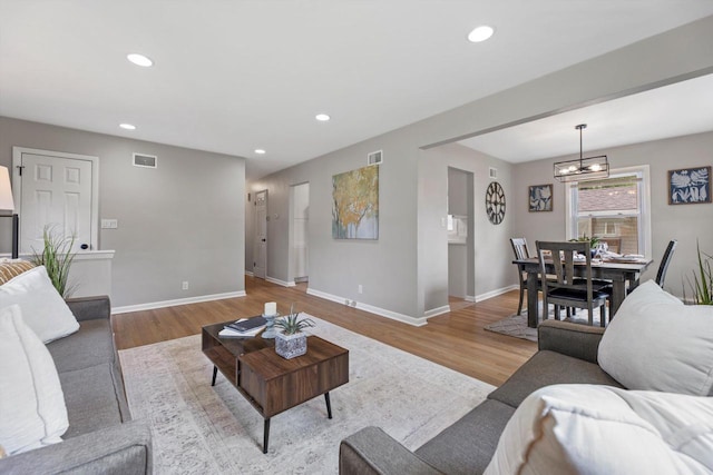 4410 N 107th St, Milwaukee, WI 53225 - living area with a chandelier, wood finished floors, and recessed lighting