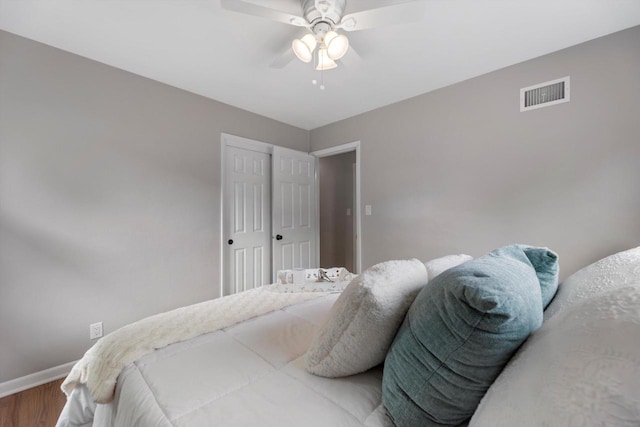 4410 N 107th St, Milwaukee, WI 53225 - bedroom with wood finished floors, a ceiling fan, and a closet