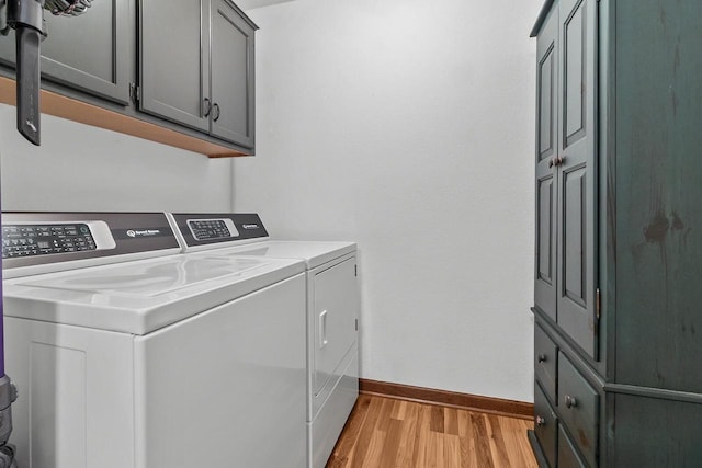 606 E Sheila Ave, Elkhorn, WI 53121 - laundry area with independent washer and dryer, light wood-type flooring, and cabinet space