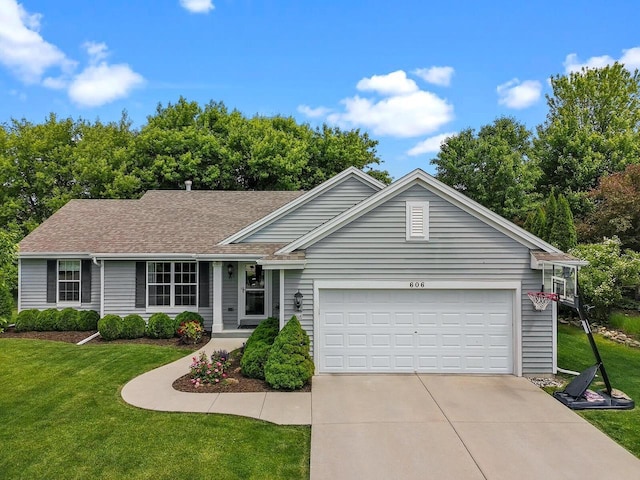 606 E Sheila Ave, Elkhorn, WI 53121 - ranch-style home featuring a front yard, a garage, driveway, and a shingled roof