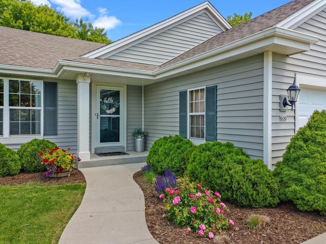 606 E Sheila Ave, Elkhorn, WI 53121 - view of exterior entry with a shingled roof and an attached garage