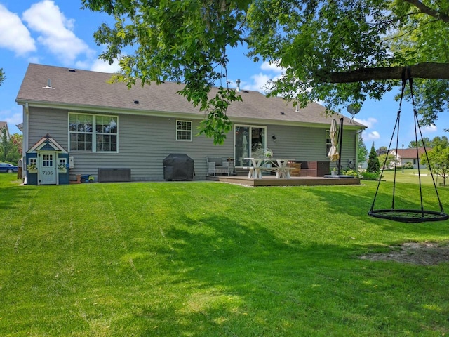 606 E Sheila Ave, Elkhorn, WI 53121 - back of property featuring a lawn and a wooden deck