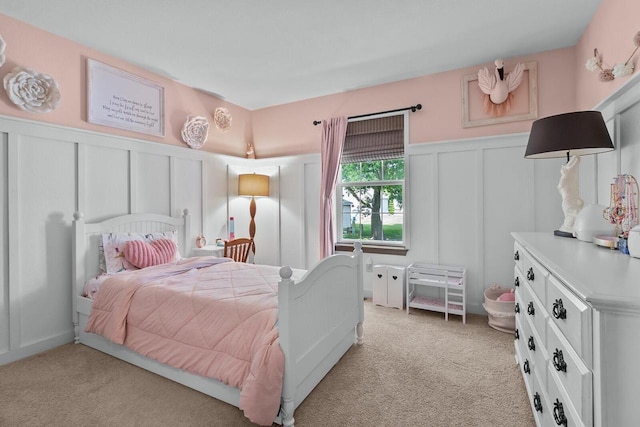 606 E Sheila Ave, Elkhorn, WI 53121 - bedroom featuring a decorative wall, light colored carpet, and wainscoting