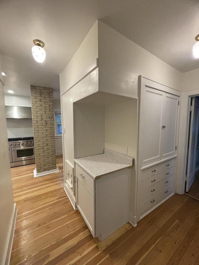 3402 N 51st Blvd, Milwaukee, WI 53216 - corridor featuring light wood finished floors and decorative columns