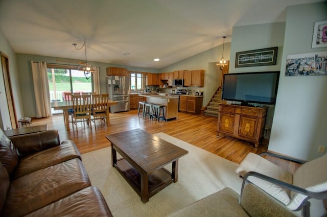 N4374 Esther Dr, Onalaska, WI 54650 - living room featuring light wood-style flooring, lofted ceiling, stairs, a chandelier, and recessed lighting