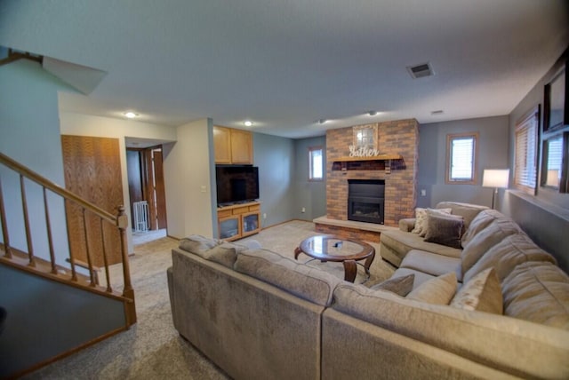 N4374 Esther Dr, Onalaska, WI 54650 - living room with a brick fireplace, carpet, stairs, and radiator heating unit