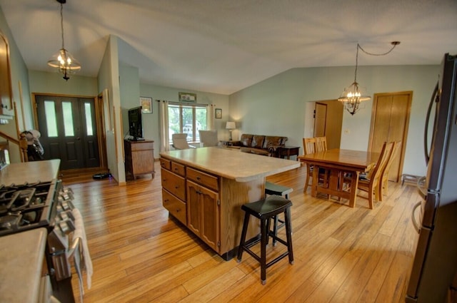 N4374 Esther Dr, Onalaska, WI 54650 - kitchen featuring stainless steel appliances, light countertops, vaulted ceiling, and light wood-style floors