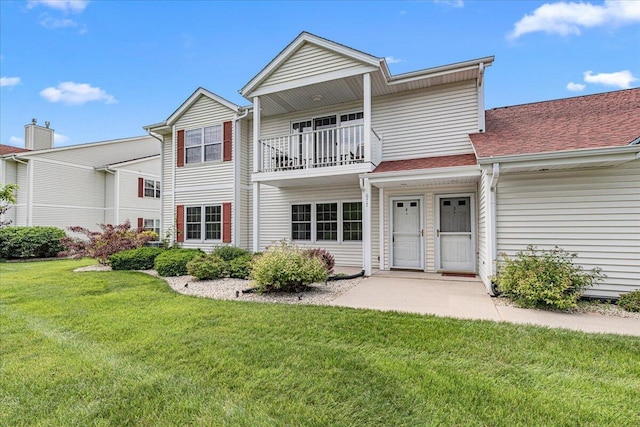 677 Wood River Ct, West Bend, WI 53095 - back of property with a yard and a balcony