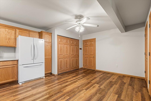 677 Wood River Ct, West Bend, WI 53095 - kitchen with freestanding refrigerator, ceiling fan, light wood finished floors, and light countertops