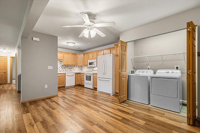 677 Wood River Ct, West Bend, WI 53095 - kitchen with white appliances, washer and clothes dryer, light wood-style floors, a ceiling fan, and light countertops