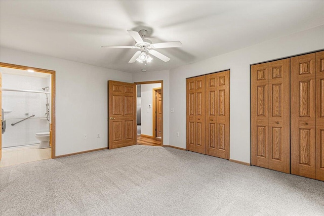 677 Wood River Ct, West Bend, WI 53095 - unfurnished bedroom with two closets, carpet floors, ensuite bath, and ceiling fan