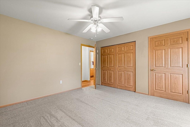677 Wood River Ct, West Bend, WI 53095 - unfurnished bedroom with carpet floors, a closet, and a ceiling fan