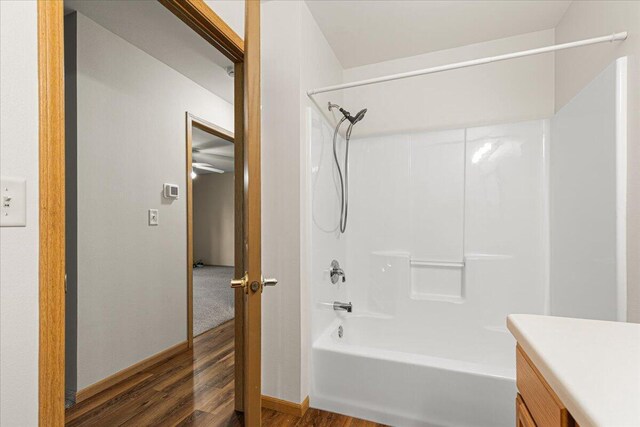 677 Wood River Ct, West Bend, WI 53095 - full bathroom featuring wood finished floors, bathing tub / shower combination, and vanity