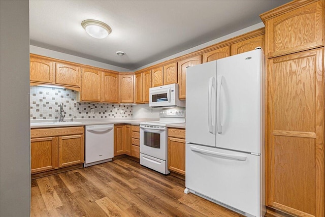 677 Wood River Ct, West Bend, WI 53095 - kitchen with white appliances, wood finished floors, backsplash, and light countertops