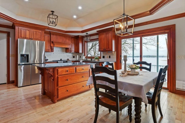 900 Hawks Holw, Delafield, WI 53018 - kitchen featuring stainless steel refrigerator with ice dispenser, a chandelier, dark countertops, decorative backsplash, and ornamental molding