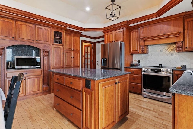 900 Hawks Holw, Delafield, WI 53018 - kitchen featuring appliances with stainless steel finishes, light wood-type flooring, a center island, and backsplash