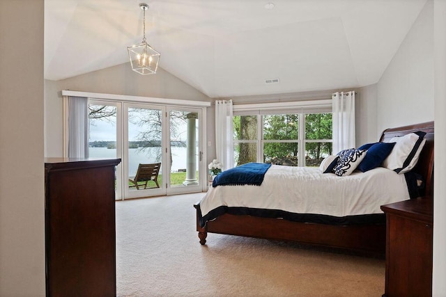 900 Hawks Holw, Delafield, WI 53018 - carpeted bedroom featuring lofted ceiling, access to exterior, multiple windows, a chandelier, and a water view