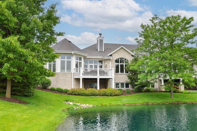 17185 Lake Rd Unit C, Brookfield, WI 53005 - back of property with brick siding, a yard, a chimney, a water view, and a sunroom