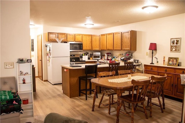 3155 Craig Rd Unit 3155, Eau Claire, WI 54701 - kitchen featuring stainless steel appliances, a peninsula, light wood finished floors, and a textured ceiling