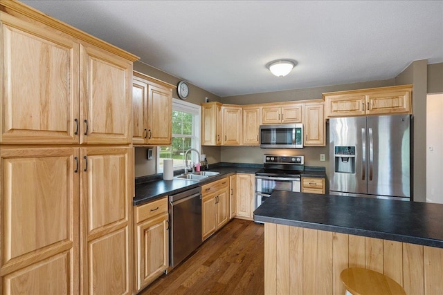 1125 W State St, Marshfield, WI 54449 - kitchen featuring appliances with stainless steel finishes, light brown cabinets, dark countertops, and dark wood-style floors