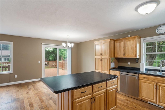 1125 W State St, Marshfield, WI 54449 - kitchen with dishwasher, light wood-style flooring, dark countertops, and a chandelier