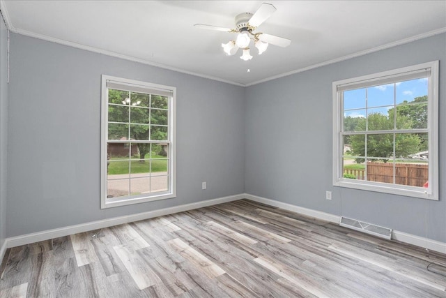1125 W State St, Marshfield, WI 54449 - unfurnished room with crown molding, healthy amount of natural light, wood finished floors, and ceiling fan