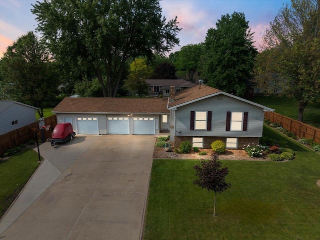 1125 W State St, Marshfield, WI 54449 - view of front facade with a garage, concrete driveway, and brick siding