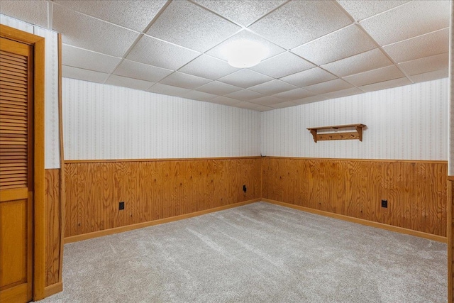 1125 W State St, Marshfield, WI 54449 - spare room with wainscoting, wooden walls, a paneled ceiling, carpet, and wallpapered walls