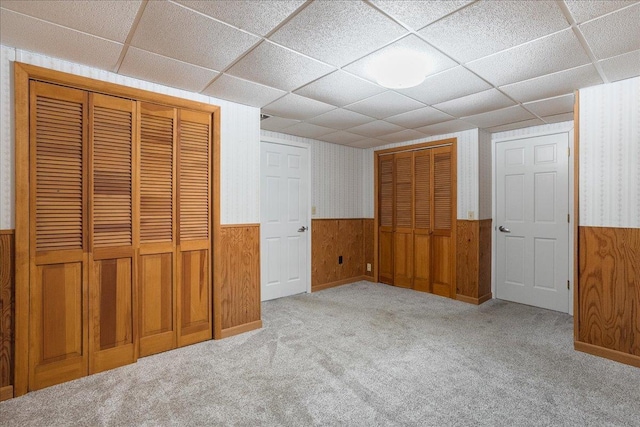 1125 W State St, Marshfield, WI 54449 - unfurnished bedroom with a wainscoted wall, carpet floors, a drop ceiling, and a closet