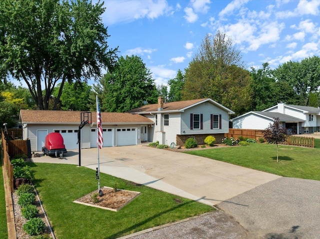 1125 W State St, Marshfield, WI 54449 - split level home featuring a garage, a chimney, concrete driveway, and brick siding