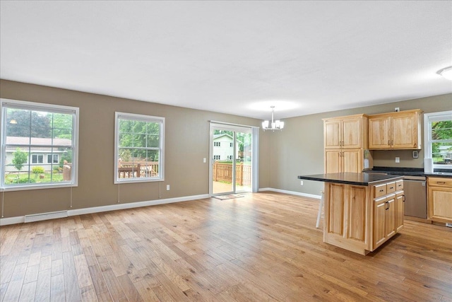 1125 W State St, Marshfield, WI 54449 - kitchen with a chandelier, dishwasher, light wood finished floors, light brown cabinetry, and dark countertops