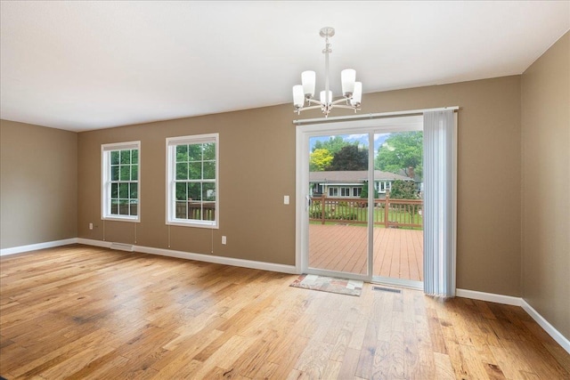 1125 W State St, Marshfield, WI 54449 - unfurnished dining area featuring a chandelier, light wood-style floors, and healthy amount of natural light