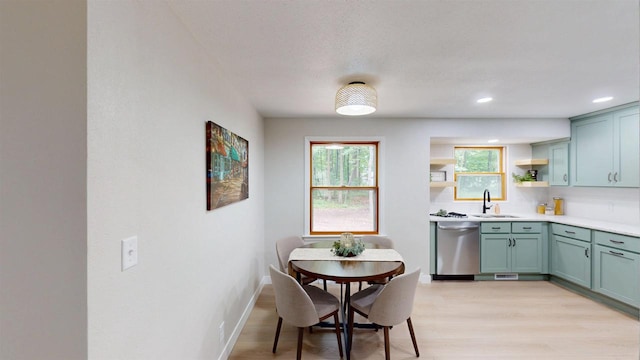 801 S Maryknoll Ave, Marshfield, WI 54449 - kitchen featuring dishwasher, open shelves, light wood-style flooring, light countertops, and recessed lighting