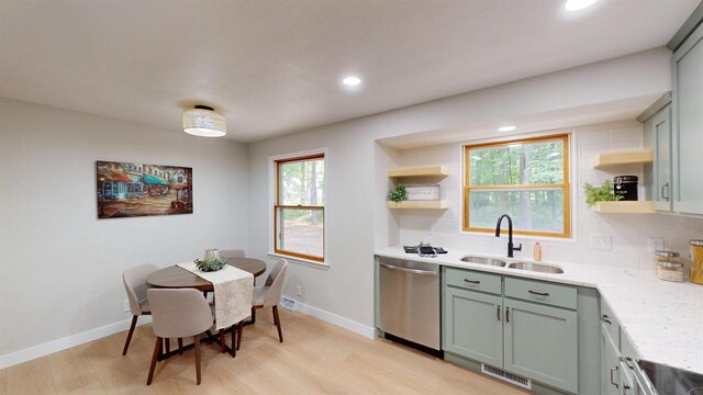 801 S Maryknoll Ave, Marshfield, WI 54449 - kitchen with dishwasher, open shelves, light wood-style floors, light countertops, and recessed lighting